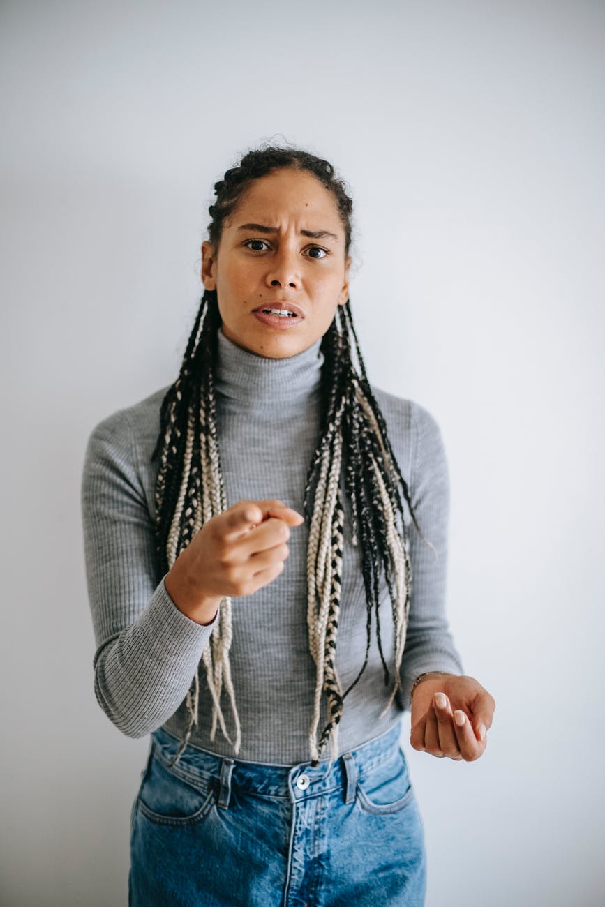 ethnic woman frowning face and pointing at camera