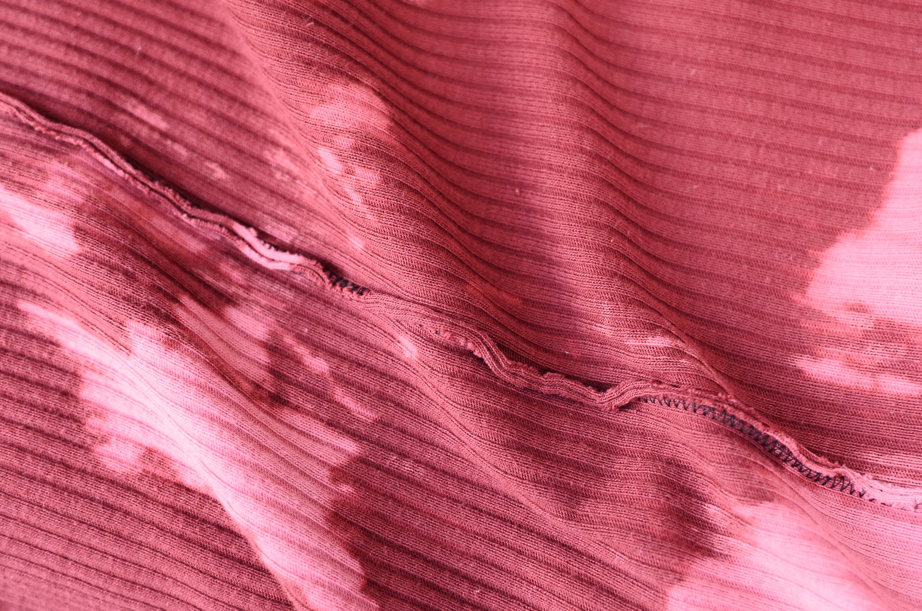 stained pink fabric placed on table inside out